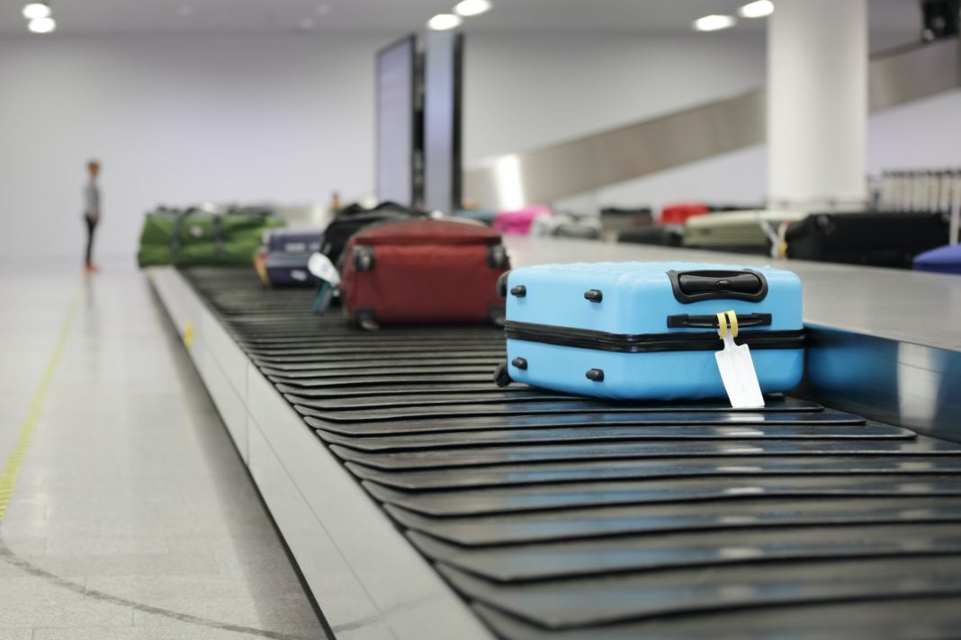Suitcase or luggage on conveyor belt in the airport