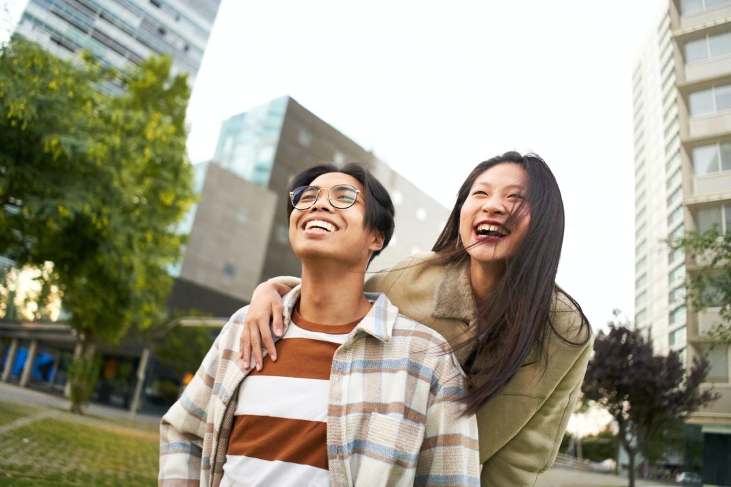 Happy asian couple traveling for honeymoon. Selfie of smiling Chinese tourist people in holidays