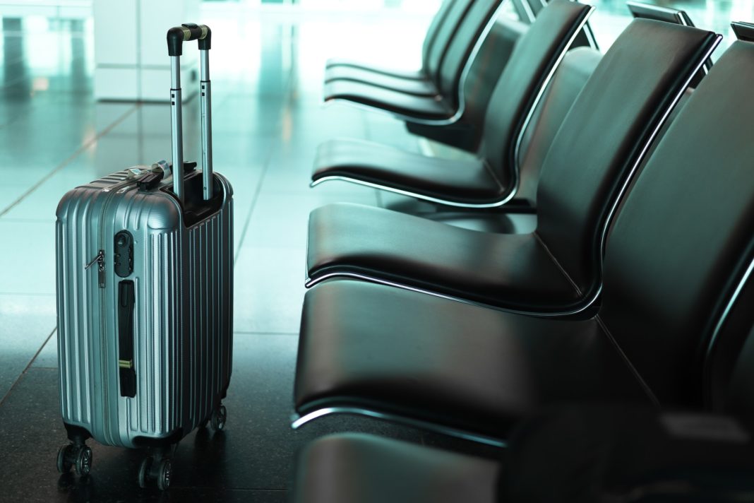 Suitcase in an empty airport departure lounge